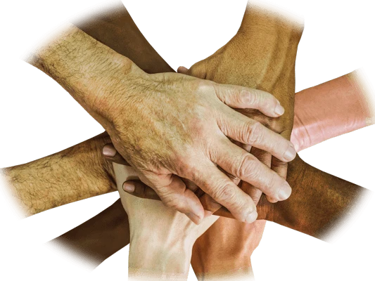 A circle of multi-racial hands on top of one another in the middle